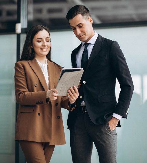 Male and female business people working on tablet in office